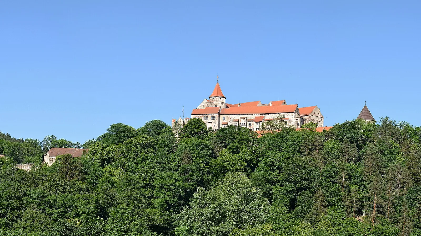 Hrad Pernštejn na skále nad lesy při pohledu z dálky